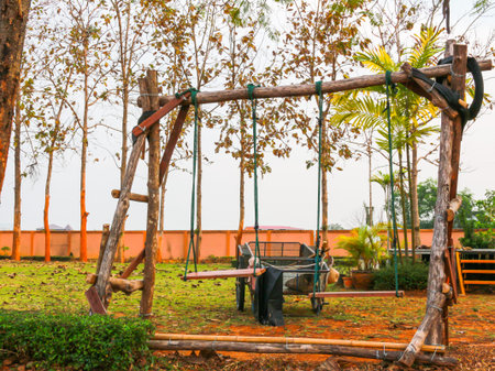 The wood swing set and vehicle in the yard for children to play.