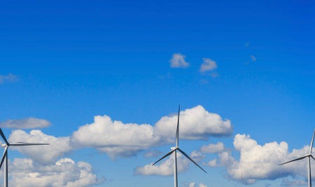 Wind turbine and white cloud in the blue sky.