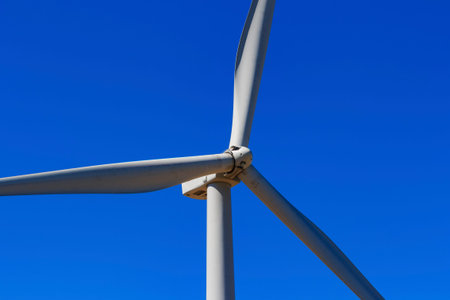Wind turbine and white cloud in the blue sky.