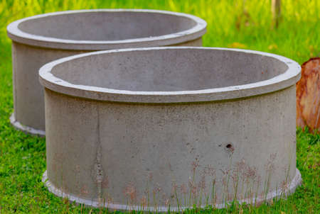 Two cement ponds on the grass.の写真素材