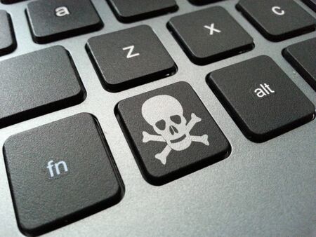 An illustration of a computer keyboard button with the skull and crossbones symbol. The illustration can be related to health risks posed by prolonged use of computer peripherals such as carpal tunnel syndrome, obesity and eye strain.の写真素材
