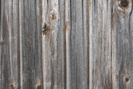 Gray wooden background from boards with traces of knots set verticallyの写真素材