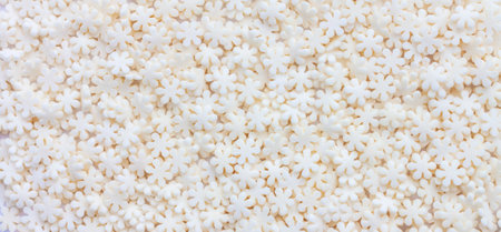 Background of white sugar flowers, pastry topping close upの写真素材