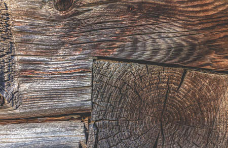Background from a fragment of a brown wooden wall at the junction of logsの写真素材