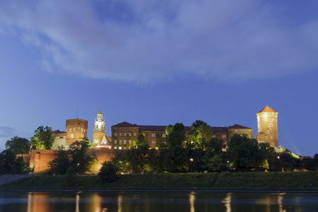 Poland, Krakow, Wawel Royal Castle Lit-up, spring, evening, seen from the south, spectacular cloudの写真素材