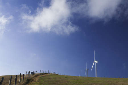 Spain, Galicia,  row of wind turbines on a hill, morning lightの写真素材