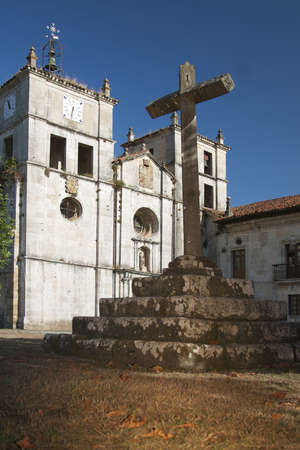 Spain, Asturias, Cornellana, Stone Cross in front af an abbeyの写真素材