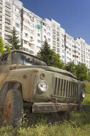 Republic of Moldova, Orhei, Communist era Housing Estate, wreck of a truck in the foreground, summer, sunlitのeditorial素材
