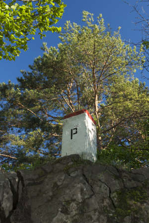 Boundary Stone, Poland, Slovakia, Szafranowka Mountain in Pieniny range, sunlit, forest in the backgroundの写真素材