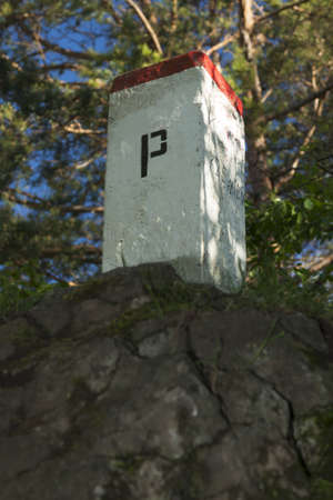Boundary Stone, Poland, Slovakia, Szafranowka Mountain in Pieniny range, sunlit, forest in the backgroundの写真素材