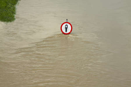 No entry sign on a flooded river embankmentの写真素材