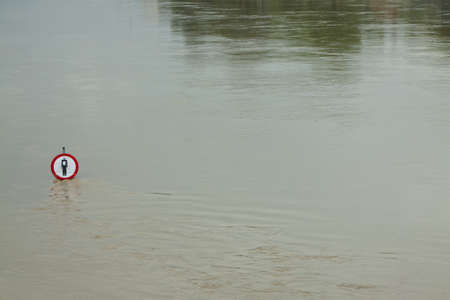 No entry sign on a flooded river embankmentの写真素材