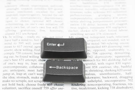 Enter and Backspace Computer Keys placed on a book pageの写真素材