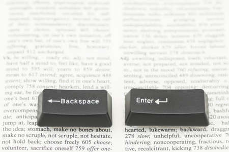 Enter and Backspace Computer Keys placed on a book pageの写真素材