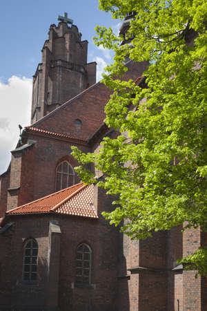 Poland, Silesia, Gliwice,All Saints church seen from north, sunlit, trees in mayの写真素材