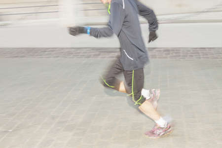 Legs of a runner on a street, motion blurの写真素材