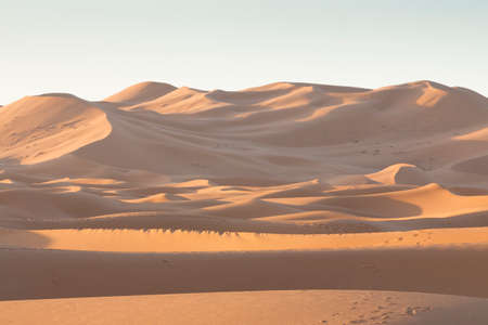 Erg Chebbi dunes at Sahara desert, Morocco, sunlit at sunriseの写真素材