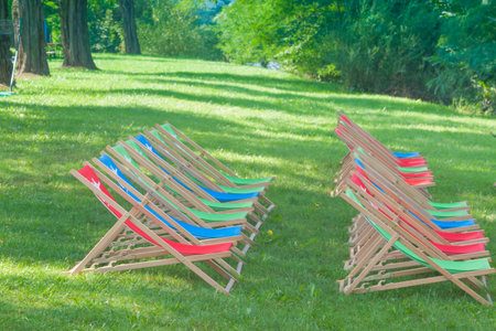 Deck Chairs in a park, sunlit, green grass