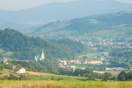 Poland, Malopolska Region, Panoramic Viev of Mszana Dolna Town and Beskid Wyspowy Mountain Range, Summer Afternoon Lightの写真素材