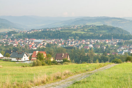Poland, Malopolska Region, Panoramic Viev of Mszana Dolna Town and Beskid Wyspowy Mountain Range, Summer Afternoon Lightの写真素材