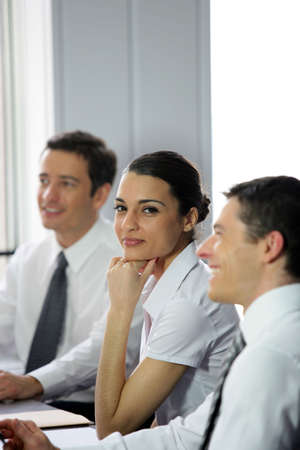 Young businesswoman around a meeting table の写真素材