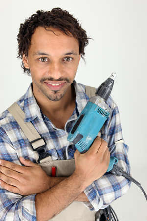 Tradesman holding an electric screwdriverの写真素材
