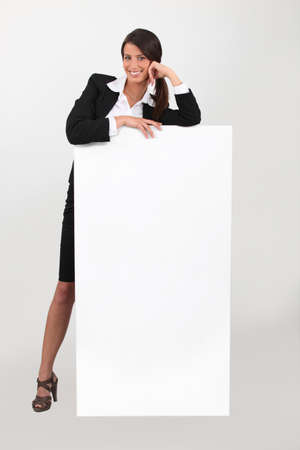Business woman with blank posterの写真素材