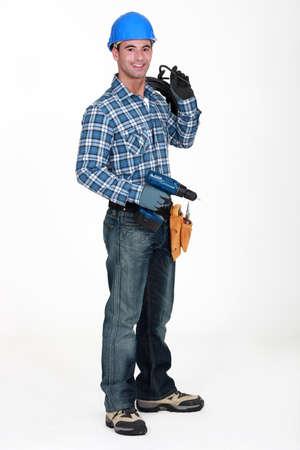 A man holding a driller.の写真素材