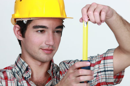 Builder holding tape measureの写真素材