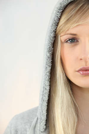 Young woman in a grey hooded sweatshirtの写真素材