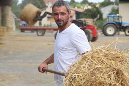 Farmer bailing hayの写真素材