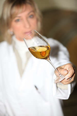 Woman examining a glass of wineの写真素材