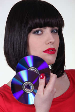 Young woman holding cdsの写真素材