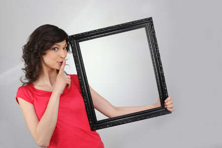 woman holding a picture frameの写真素材
