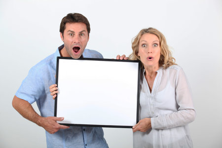 Couple holding advertising board