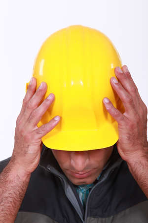 craftsman putting on his helmetの写真素材