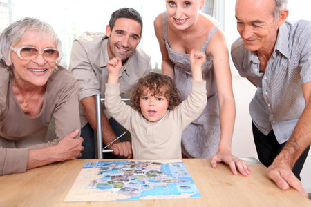 Family gathered around jigsaw puzzle