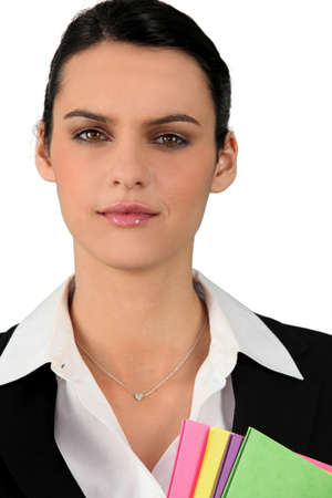 Professional brunette holding office filesの写真素材