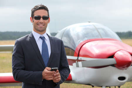 Man next to a light aircraftの写真素材