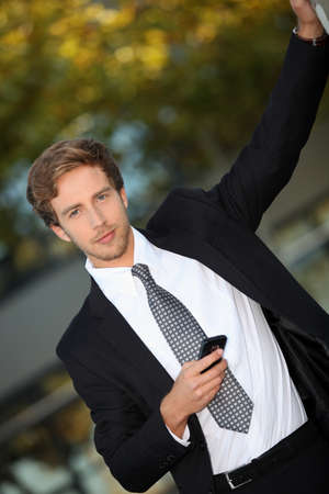 Young man in smart suit with mobile phoneの写真素材