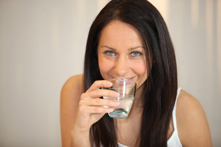 brunette woman drinking water