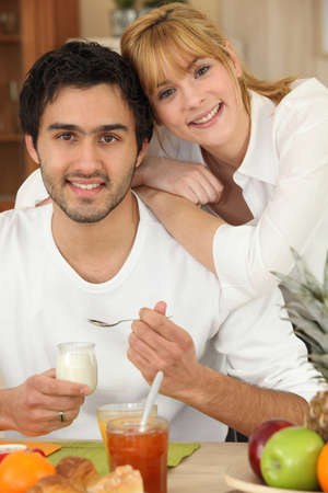 Young couple eating breakfastの写真素材
