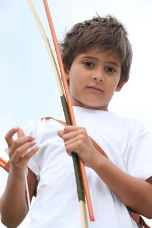 Young boy with bow and arrowの写真素材