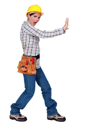 Woman pushing against an imaginary wallの写真素材