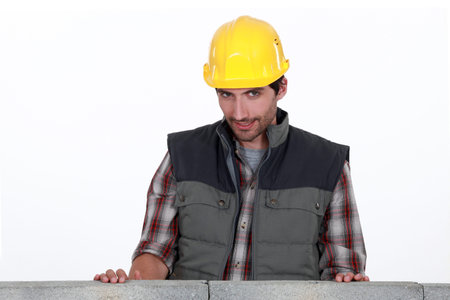 Shy worker behind wall