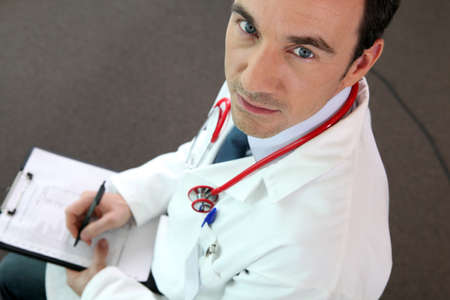 a doctor writing on a paperの写真素材