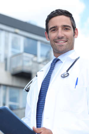 Doctor standing outside a hospitalの写真素材