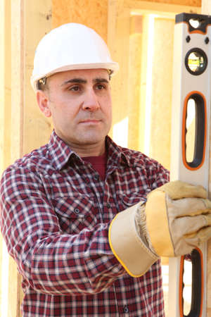 Construction worker using a spirit levelの写真素材