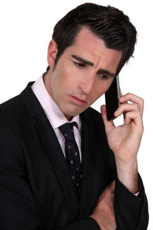 businessman on the phone looking concernedの写真素材