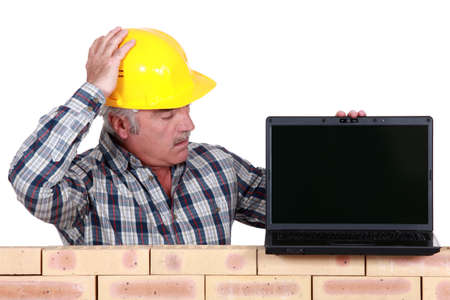 A mason with a laptop.の写真素材
